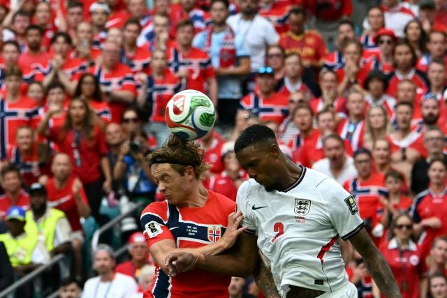 Norway's midfielder #06 Patrick Berg (L) and England's defender #02 Ezri Konsa fight for a header during the 2026 World Cup football tournament quarter-final match between Norway and England at Miami Stadium in Miami on July 11, 2026.  (Photo by ROBERTO SCHMIDT / AFP)