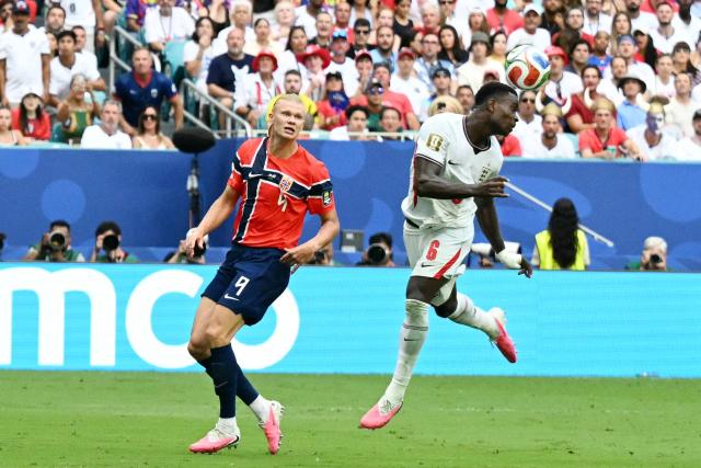 England's defender #06 Marc Guehi heads the ball past Norway's forward #09 Erling Braut Haaland during the 2026 World Cup football tournament quarter-final match between Norway and England at Miami Stadium in Miami Gardens on July 11, 2026.  (Photo by CHANDAN KHANNA / AFP)