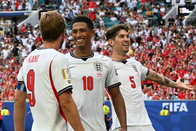 England's midfielder #10 Jude Bellingham celebrates scoring his team's second goal with England's forward #09 Harry Kane and England's defender #05 John Stones during the 2026 World Cup football tournament quarter-final match between Norway and England at Miami Stadium in Miami on July 11, 2026.  (Photo by ROBERTO SCHMIDT / AFP)