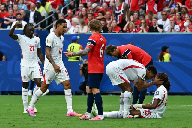 England's defender #25 Djed Spence celebrates with England's midfielder #10 Jude Bellingham a penalty decision which was later disallowed after a VAR review during the 2026 World Cup football tournament quarter-final match between Norway and England at Miami Stadium in Miami on July 11, 2026.  (Photo by ROBERTO SCHMIDT / AFP)