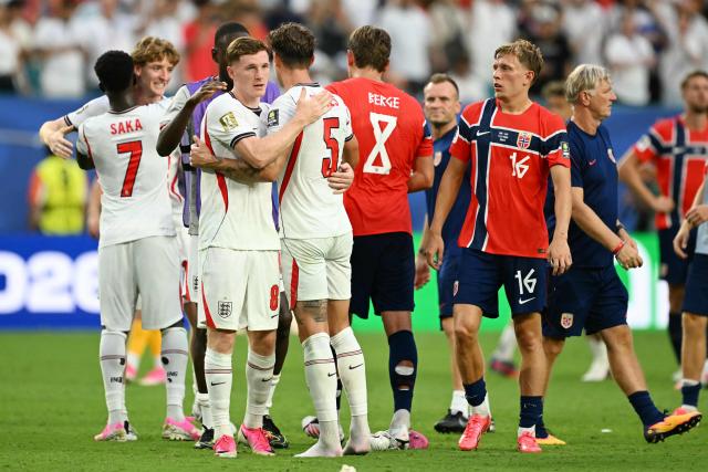 England's midfielder #08 Elliot Anderson and defender #05 John Stones hug after the 2026 World Cup football tournament quarter-final match between Norway and England at Miami Stadium in Miami Gardens on July 11, 2026.  (Photo by CHANDAN KHANNA / AFP)