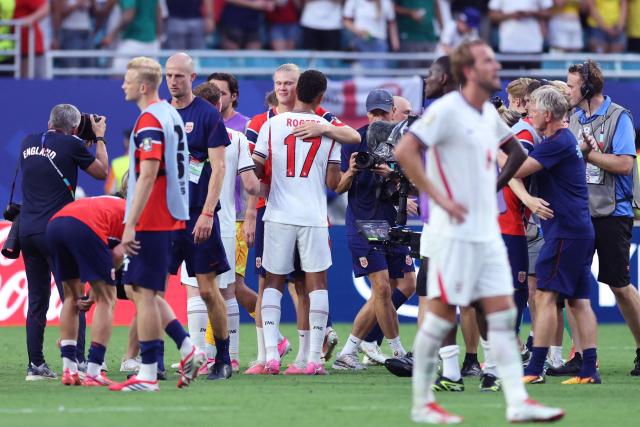 England's midfielder #17 Morgan Rogers embraces Norway's forward #09 Erling Braut Haaland at the end of the 2026 World Cup football tournament quarter-final match between Norway and England at Miami Stadium in Miami Gardens on July 11, 2026.  (Photo by PATRICIA DE MELO MOREIRA / AFP)