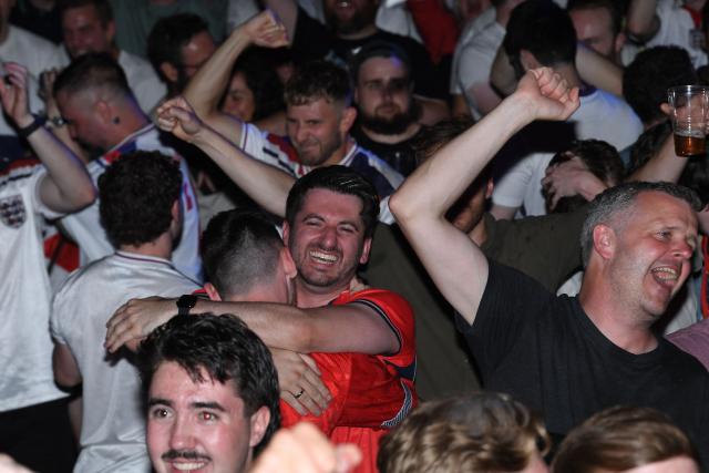 England fans celebrate England's victory after watching the 2026 World Cup quarter-final football match between England and Norway, at Camp and Furnace in Liverpool, north-west England early on July 12, 2026. (Photo by PETER POWELL / AFP)