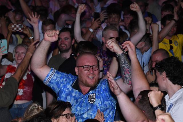 England fans celebrate England's victory after watching the 2026 World Cup quarter-final football match between England and Norway, at Camp and Furnace in Liverpool, north-west England early on July 12, 2026. (Photo by PETER POWELL / AFP)