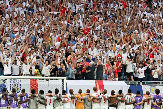 England's players watch the fans celebrating the 2-1 victory over Norway at the end of the 2026 World Cup football tournament quarter-final match between Norway and England at Miami Stadium in Miami on July 11, 2026.  (Photo by ROBERTO SCHMIDT / AFP)
