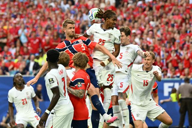 England's defender #25 Djed Spence and Norway's defender #03 Kristoffer Vassbakk Ajer jump for a header during the 2026 World Cup football tournament quarter-final match between Norway and England at Miami Stadium in Miami on July 11, 2026.  (Photo by ROBERTO SCHMIDT / AFP)