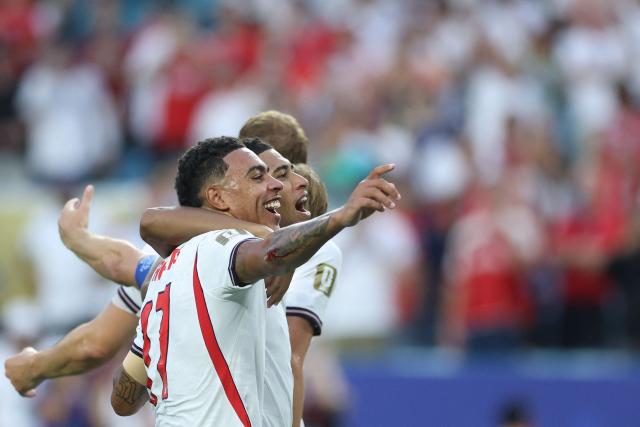 England's midfielders #10 Jude Bellingham (R) and #17 Morgan Rogers celebrate after winning the 2026 World Cup football tournament quarter-final match between Norway and England at Miami Stadium in Miami Gardens on July 11, 2026.  (Photo by PATRICIA DE MELO MOREIRA / AFP)