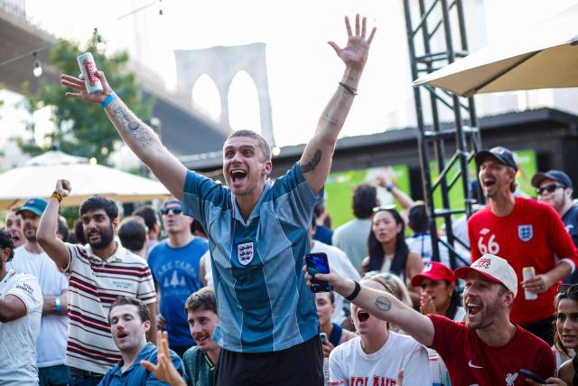 England fans react as their team scores a goal during a watch party of the World Cup quarterfinal football match between England and Norway at a fan zone in DUMBO (Down Under the Manhattan Bridge Overpass), a neighborhood in Brooklyn, New York, on July 11, 2026. (Photo by kena betancur / AFP)