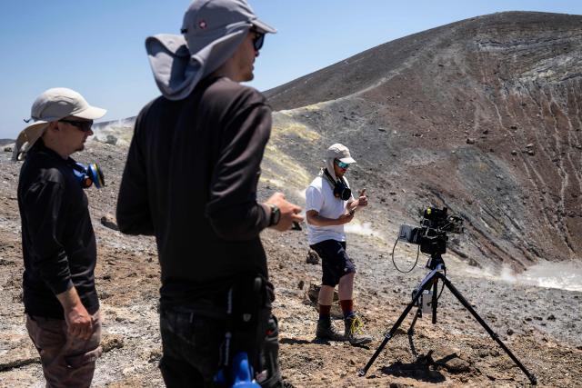 Vulcanologists from the University of Munich work with a laser instrument to gather data from a drone in the crater of La Fossa, on Vulcano Island, one of the seven islands of the Aeolian Archipelago of Sicily, on July 9, 2026. A team of researchers from Germany are testing a new system for measuring volcanic gases to better anticipate future eruptions. Hovering over the crater of La Fossa, a drone positions itself in front of a laser beam set at the edge of the chasm on Vulcano, off Sicily, and collect data. (Photo by Marco Bertorello / AFP)