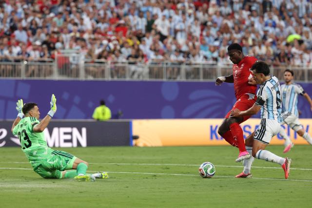 Switzerland's forward #07 Breel Embolo and Argentina's defender #06 Lisandro Martinez fight for the ball as Argentina's goalkeeper #23 Emiliano Martinez defends his goal during the 2026 World Cup football tournament quarter-final match between Argentina and Switzerland at the Kansas City Stadium in Kansas City on July 11, 2026.  (Photo by Odd ANDERSEN / AFP)