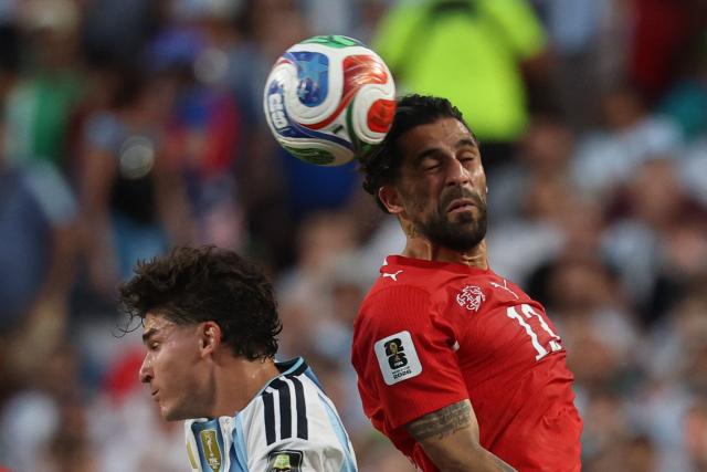 Switzerland's defender #13 Ricardo Rodriguez (R) and Argentina's forward #09 Julian Alvarez jump for a header during the 2026 World Cup football tournament quarter-final match between Argentina and Switzerland at the Kansas City Stadium in Kansas City on July 11, 2026.  (Photo by Odd ANDERSEN / AFP)