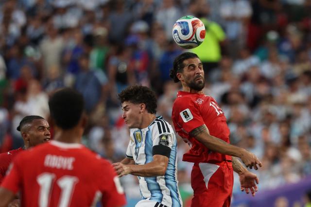 Switzerland's defender #13 Ricardo Rodriguez (R) and Argentina's forward #09 Julian Alvarez jump for a header during the 2026 World Cup football tournament quarter-final match between Argentina and Switzerland at the Kansas City Stadium in Kansas City on July 11, 2026.  (Photo by Odd ANDERSEN / AFP)