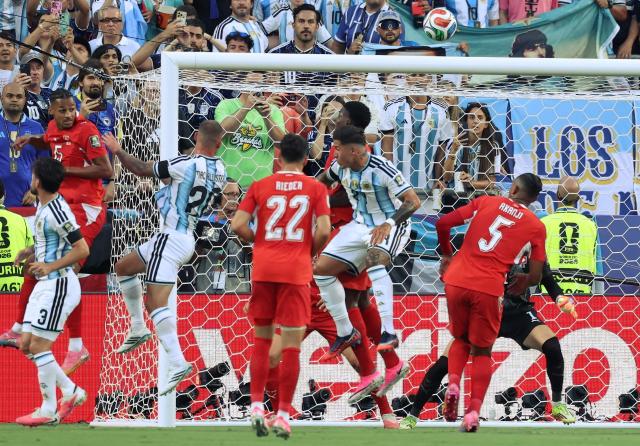 Argentina's midfielder #20 Alexis Mac Allister (3rd-L) heads the ball to score his team's first goal during the 2026 World Cup football tournament quarter-final match between Argentina and Switzerland at the Kansas City Stadium in Kansas City on July 11, 2026.  (Photo by Thomas COEX / AFP)