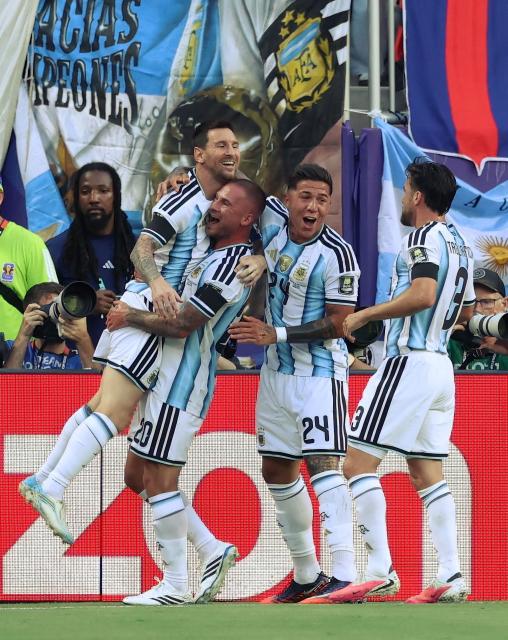 Argentina's midfielder #20 Alexis Mac Allister (C-L) celebrate with Argentina's forward #10 Lionel Messi, Argentina's midfielder #24 Enzo Fernandez and Argentina's defender #03 Nicolas Tagliafico after scoring his team's first goal during the 2026 World Cup football tournament quarter-final match between Argentina and Switzerland at the Kansas City Stadium in Kansas City on July 11, 2026.  (Photo by Thomas COEX / AFP)