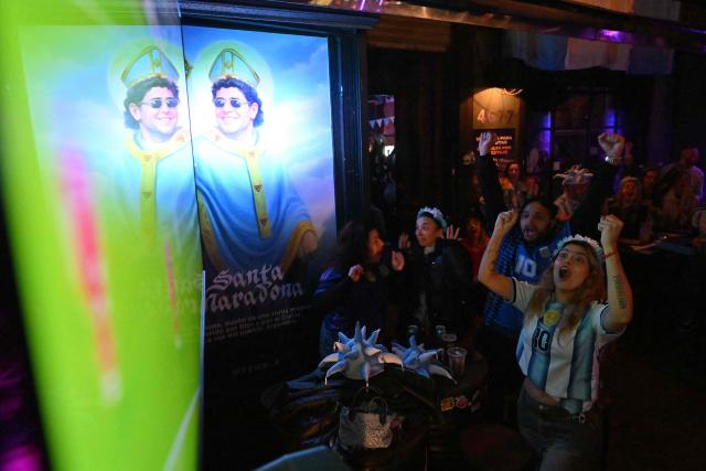 Fans of Argentina react as they watch the 2026 World Cup football tournament quarter-final match between Argentina and Switzerland on a giant screen in Buenos Aires on July 11, 2026. (Photo by Luis ROBAYO / AFP)