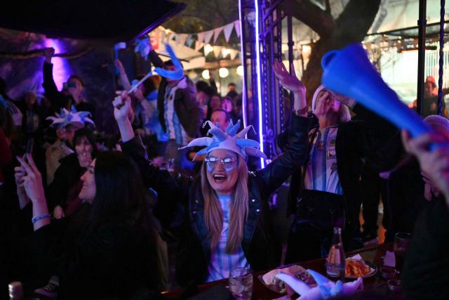 Fans of Argentina react as they watch the 2026 World Cup football tournament quarter-final match between Argentina and Switzerland on a giant screen in Buenos Aires on July 11, 2026. (Photo by Luis ROBAYO / AFP)
