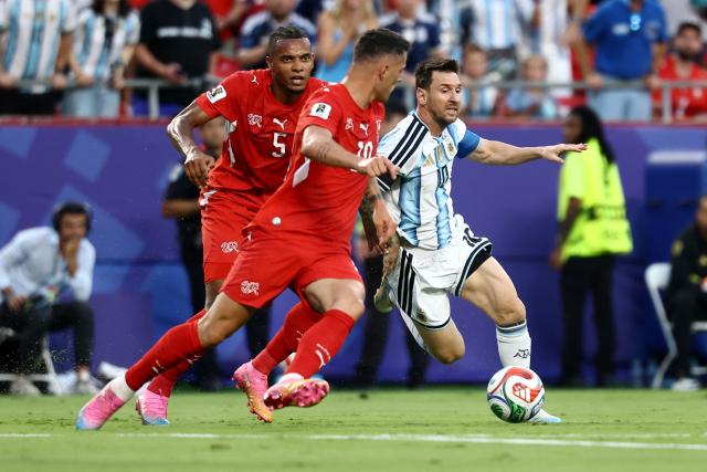 TOPSHOT - Switzerland's midfielder #10 Granit Xhaka and Argentina's forward #10 Lionel Messi fight for the ball during the 2026 World Cup football tournament quarter-final match between Argentina and Switzerland at the Kansas City Stadium in Kansas City on July 11, 2026.  (Photo by CHARLY TRIBALLEAU / AFP)