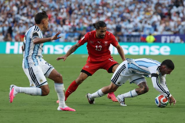 Argentina's midfielder #07 Rodrigo De Paul (R) is fouled by Switzerland's defender #13 Ricardo Rodriguez during the 2026 World Cup football tournament quarter-final match between Argentina and Switzerland at the Kansas City Stadium in Kansas City on July 11, 2026.  (Photo by Odd ANDERSEN / AFP)
