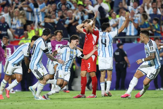 Argentina's forward #09 Julian Alvarez celebrates scoring his team's second goal as Switzerland's defender #03 Silvan Widmer reacts during the 2026 World Cup football tournament quarter-final match between Argentina and Switzerland at the Kansas City Stadium in Kansas City on July 11, 2026.  (Photo by Thomas COEX / AFP)