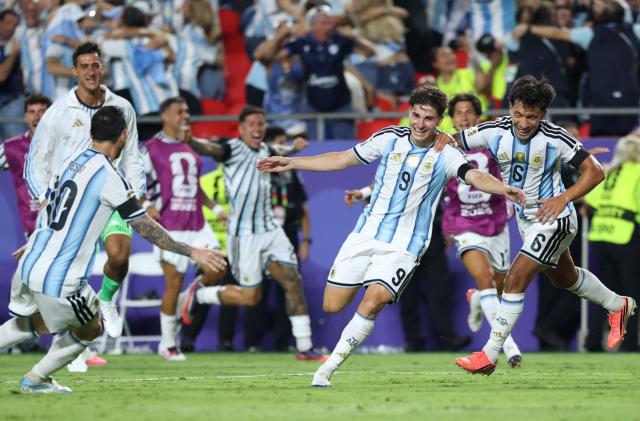 Argentina's forward #09 Julian Alvarez celebrates scoring his team's second goal with Argentina's forward #10 Lionel Messi and Argentina's defender #06 Lisandro Martinez during the 2026 World Cup football tournament quarter-final match between Argentina and Switzerland at the Kansas City Stadium in Kansas City on July 11, 2026.  (Photo by Thomas COEX / AFP)