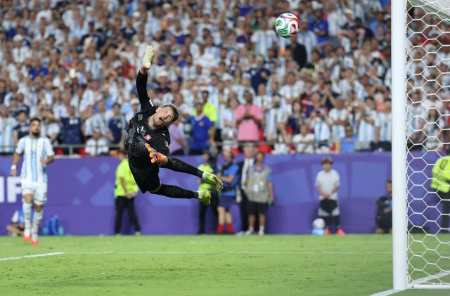 Switzerland's goalkeeper #01 Gregor Kobel dives but fails to save a goal scored by Argentina's forward #09 Julian Alvarez (unseen) during the 2026 World Cup football tournament quarter-final match between Argentina and Switzerland at the Kansas City Stadium in Kansas City on July 11, 2026.  (Photo by Thomas COEX / AFP)