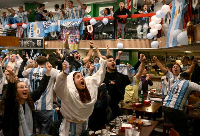 Fans of Argentina celebrate their team's second goal of the 2026 World Cup football tournament quarter-final match between Argentina and Switzerland, on a giant screen in Buenos Aires on July 11, 2026. (Photo by Luis ROBAYO / AFP)
