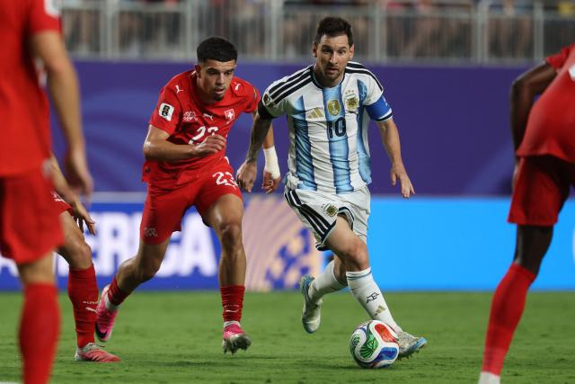 Argentina's forward #10 Lionel Messi runs with the ball followed by Switzerland's forward #23 Zeki Amdouni during the 2026 World Cup football tournament quarter-final match between Argentina and Switzerland at the Kansas City Stadium in Kansas City on July 11, 2026.  (Photo by Odd ANDERSEN / AFP)