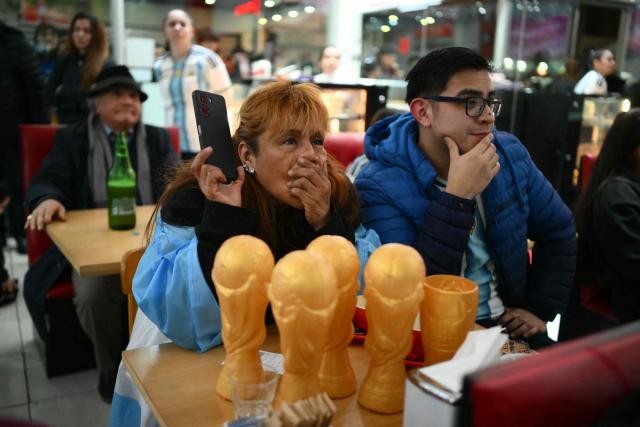 Fans of Argentina react as they watch the 2026 World Cup football tournament quarter-final match between Argentina and Switzerland on a giant screen in Buenos Aires on July 11, 2026. (Photo by Luis ROBAYO / AFP)
