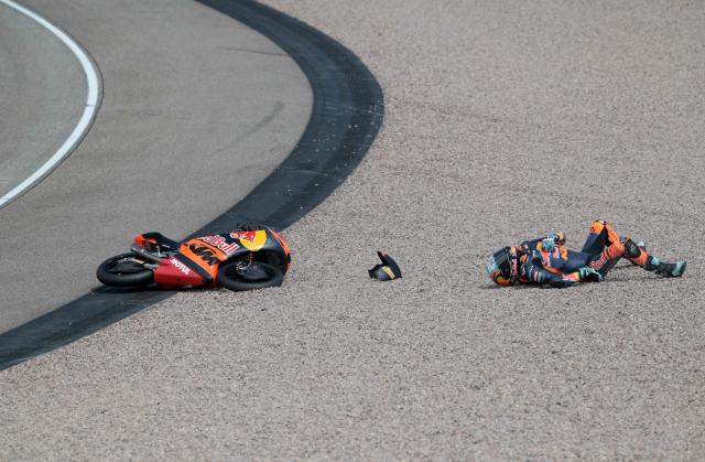 Red Bull KTM Tech3 Team's Argentinian driver Valentin Perrone lies in the gravel trap after crashing during the Moto3 race at the Sachsenring race track in Hohenstein-Ernstthal near Chemnitz, eastern Germany, on July 12, 2026, ahead of the German Motorcycle MotoGP Grand Prix. (Photo by Ronny HARTMANN / AFP)