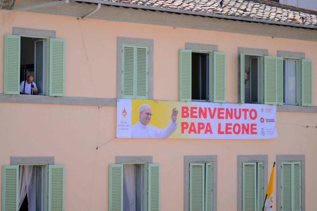 A banner on a building reads "Welcome Pope Leo", before Pope Leo XIV Angelus prayer in Piazza della Liberta (Liberty Square) at the summer papal residence in Castel Gandolfo on 12 July 2026. (Photo by Tiziana FABI / AFP)