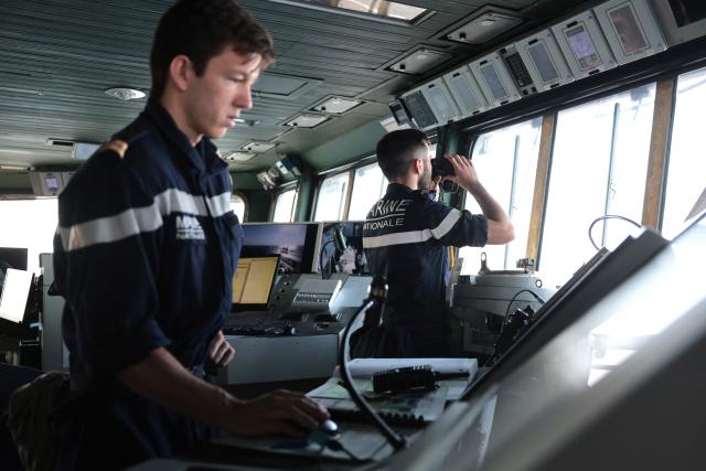 French Navy officers work in the navigation deck of the Charles de Gaulle aircraft carrier as it returns from its 'Lafayette 26' mission near Bonifacio off the coast of the French island of Corsica, southern France on July 10, 2026. (Photo by Pascal POCHARD-CASABIANCA / AFP)