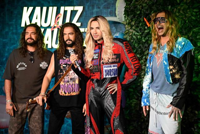 German musician Tom Kaulitz (L) and his twin brother Bill Kaulitz (R) from the German band "Tokio Hotel" pose with their wax likenesses during the unveiling of their figures at Madame Tussauds wax museum in Berlin on July 12, 2026. (Photo by Tobias SCHWARZ / AFP)