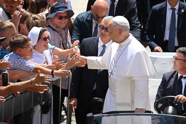 Pope Leo XIV greets the crowd after the Angelus prayer from the entrance of the Apostolic Palace in Piazza della Liberta (Liberty Square) at the summer papal residence in Castel Gandolfo on 12 July 2026. (Photo by Tiziana FABI / AFP)