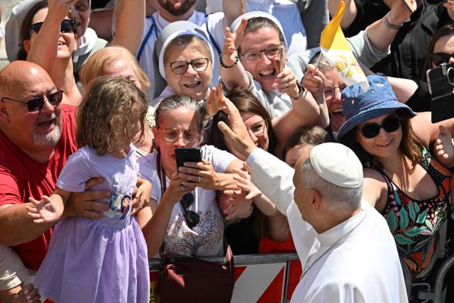 Pope Leo XIV greets the crowd after the Angelus prayer from the entrance of the Apostolic Palace in Piazza della Liberta (Liberty Square) at the summer papal residence in Castel Gandolfo on 12 July 2026. (Photo by Tiziana FABI / AFP)