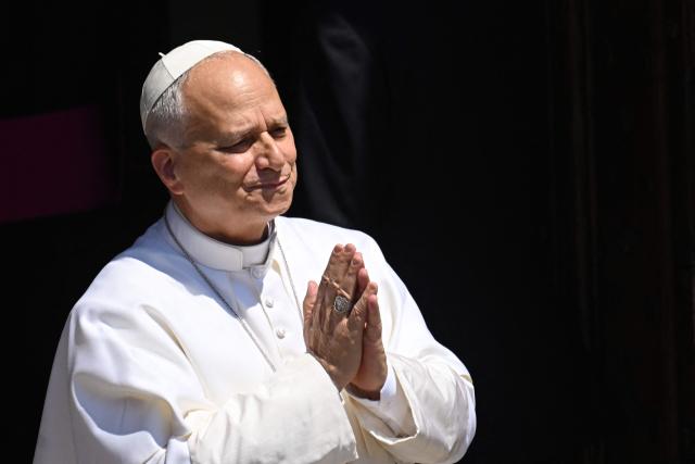 Pope Leo XIV greets the crowd after the Angelus prayer from the entrance of the Apostolic Palace in Piazza della Liberta (Liberty Square) at the summer papal residence in Castel Gandolfo on 12 July 2026. (Photo by Tiziana FABI / AFP)