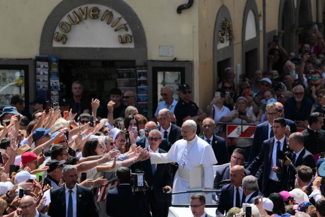 Pope Leo XIV greets the crowd after the Angelus prayer from the entrance of the Apostolic Palace in Piazza della Liberta (Liberty Square) at the summer papal residence in Castel Gandolfo on 12 July 2026. (Photo by Tiziana FABI / AFP)