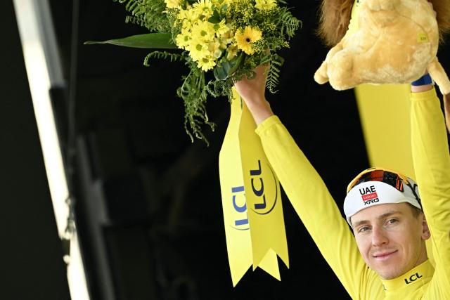 UAE Team Emirates - XRG's Slovenian rider Tadej Pogacar celebrates on the podium with the overall leader's yellow jersey after the 9th stage of the 113th edition of the Tour de France cycling race, 154,6 km between Malemort and Ussel in central France, on July 12, 2026. (Photo by Loic VENANCE / AFP)
