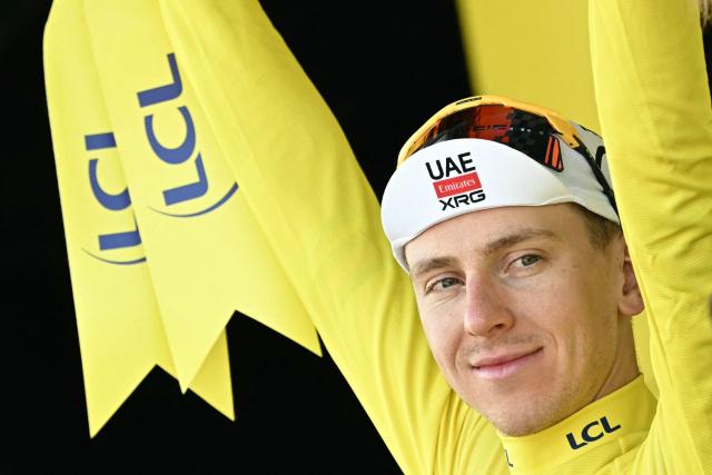 UAE Team Emirates - XRG's Slovenian rider Tadej Pogacar celebrates on the podium with the overall leader's yellow jersey after the 9th stage of the 113th edition of the Tour de France cycling race, 154,6 km between Malemort and Ussel in central France, on July 12, 2026. (Photo by Loic VENANCE / AFP)
