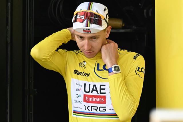 UAE Team Emirates - XRG's Slovenian rider Tadej Pogacar celebrates on the podium with the overall leader's yellow jersey after the 9th stage of the 113th edition of the Tour de France cycling race, 154,6 km between Malemort and Ussel in central France, on July 12, 2026. (Photo by Loic VENANCE / AFP)