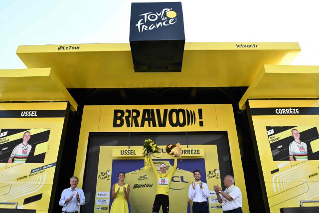 UAE Team Emirates - XRG's Slovenian rider Tadej Pogacar celebrates on the podium with the overall leader's yellow jersey after the 9th stage of the 113th edition of the Tour de France cycling race, 154,6 km between Malemort and Ussel in central France, on July 12, 2026. (Photo by Jeff PACHOUD / AFP)