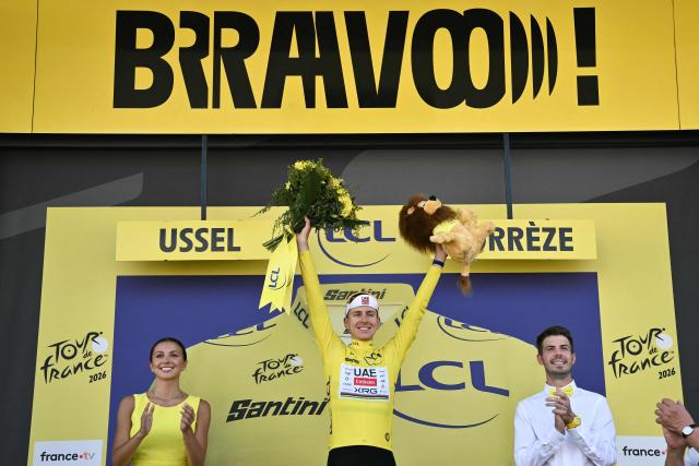 UAE Team Emirates - XRG's Slovenian rider Tadej Pogacar celebrates on the podium with the overall leader's yellow jersey after the 9th stage of the 113th edition of the Tour de France cycling race, 154,6 km between Malemort and Ussel in central France, on July 12, 2026. (Photo by Jeff PACHOUD / AFP)