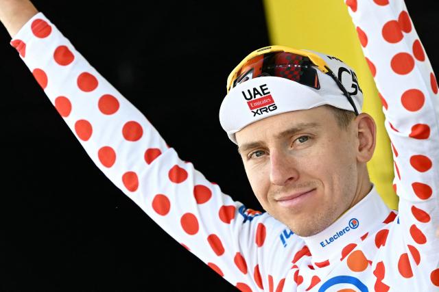 UAE Team Emirates - XRG's Slovenian rider Tadej Pogacar celebrates on the podium with the best climber's polka dot (dotted) jersey after the 9th stage of the 113th edition of the Tour de France cycling race, 154,6 km between Malemort and Ussel in central France, on July 12, 2026. (Photo by Loic VENANCE / AFP)