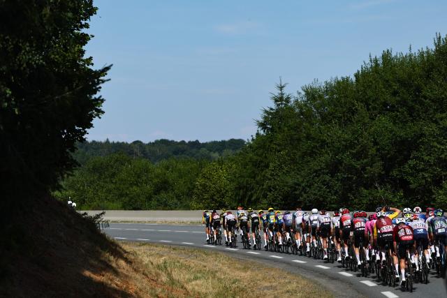 The pack of riders (peloton) cycles during the 9th stage of the 113th edition of the Tour de France cycling race, 154,6 km between Malemort and Ussel in central France, on July 12, 2026. (Photo by Anne-Christine POUJOULAT / AFP)