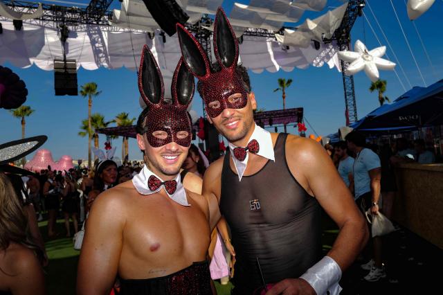 People pose as they arrive to attend the "Bal des fous" festive event at the Palais des Festivals in Cannes, French Riviera, on July 12, 2026. (Photo by Valery HACHE / AFP)