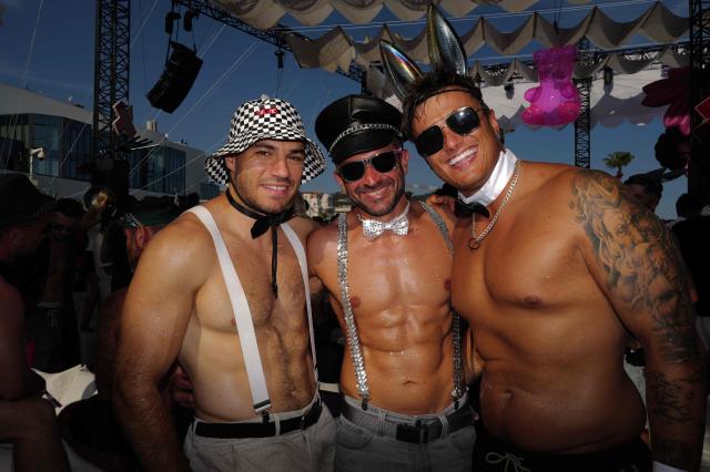 People pose as they arrive to attend the "Bal des fous" festive event at the Palais des Festivals in Cannes, French Riviera, on July 12, 2026. (Photo by Valery HACHE / AFP)