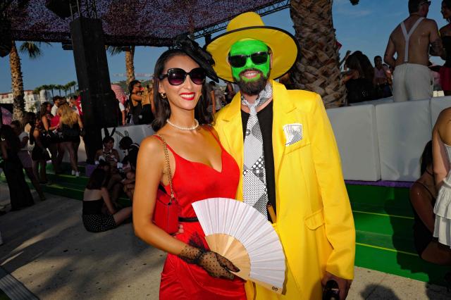 People pose as they arrive to attend the "Bal des fous" festive event at the Palais des Festivals in Cannes, French Riviera, on July 12, 2026. (Photo by Valery HACHE / AFP)