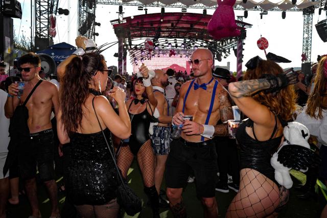 People take part in the "Bal des fous" festive event at the Palais des Festivals in Cannes, French Riviera, on July 12, 2026. (Photo by Valery HACHE / AFP)