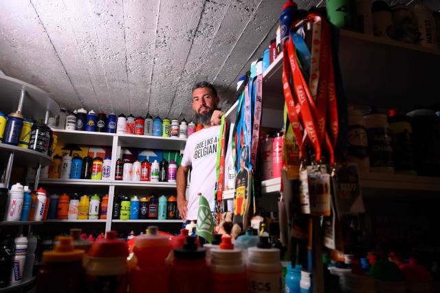 Cycling enthusiast Cedric Raemmackers poses with his collection of around 6,000 cyclists' hydration bottles which he has been collecting since 1992, in his home in Wanze, on June 22, 2026. (Photo by JOHN THYS / AFP)