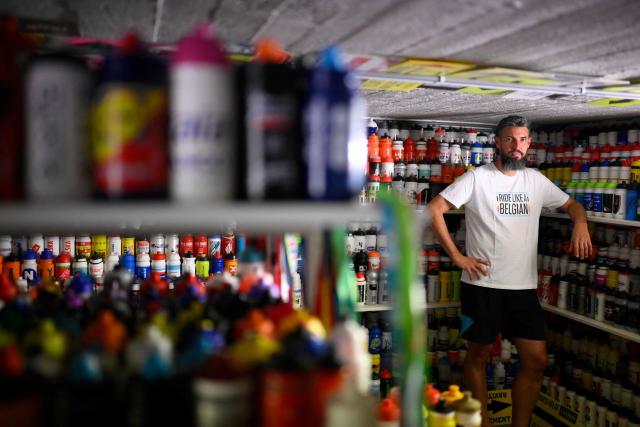 Cycling enthusiast Cedric Raemmackers poses with his collection of around 6,000 cyclists' hydration bottles which he has been collecting since 1992, in his home in Wanze, on June 22, 2026. (Photo by JOHN THYS / AFP)