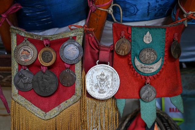 Medals won by fourteen-year-old jockey Zolboo Gantumur are displayed at his house on the outskirts of Ulaanbaatar on June 23, 2026. Six-year-old Hurts Gantumur raced across the Mongolian grasslands astride a galloping horse, training to become a child jockey in the country's biggest cultural festival. (Photo by Adek BERRY / AFP) / To go with 'Mongolia-Festival-Jockey' Visual story by Mungunsor Purevsuren